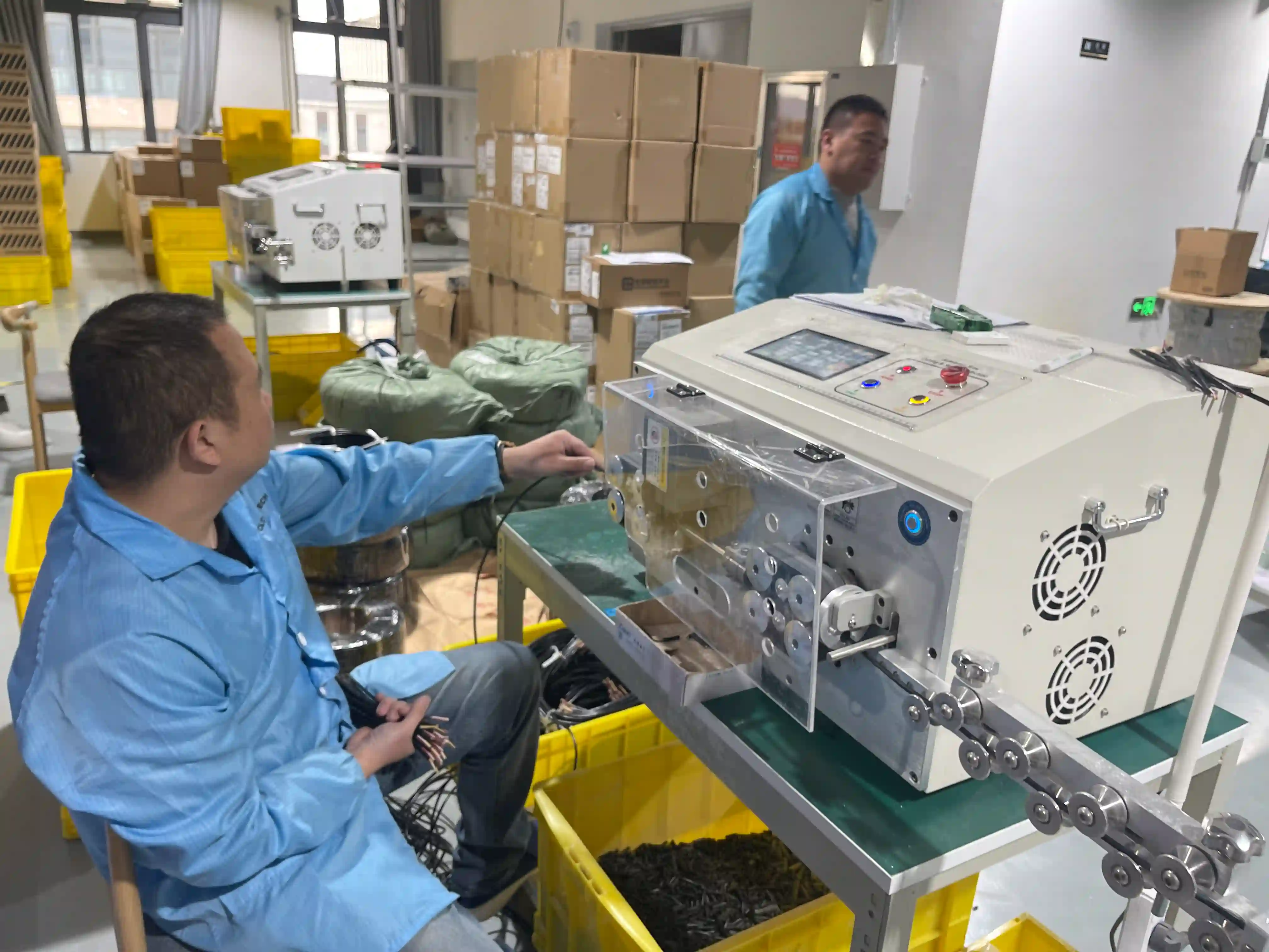 Operador supervisando máquina de corte de cables